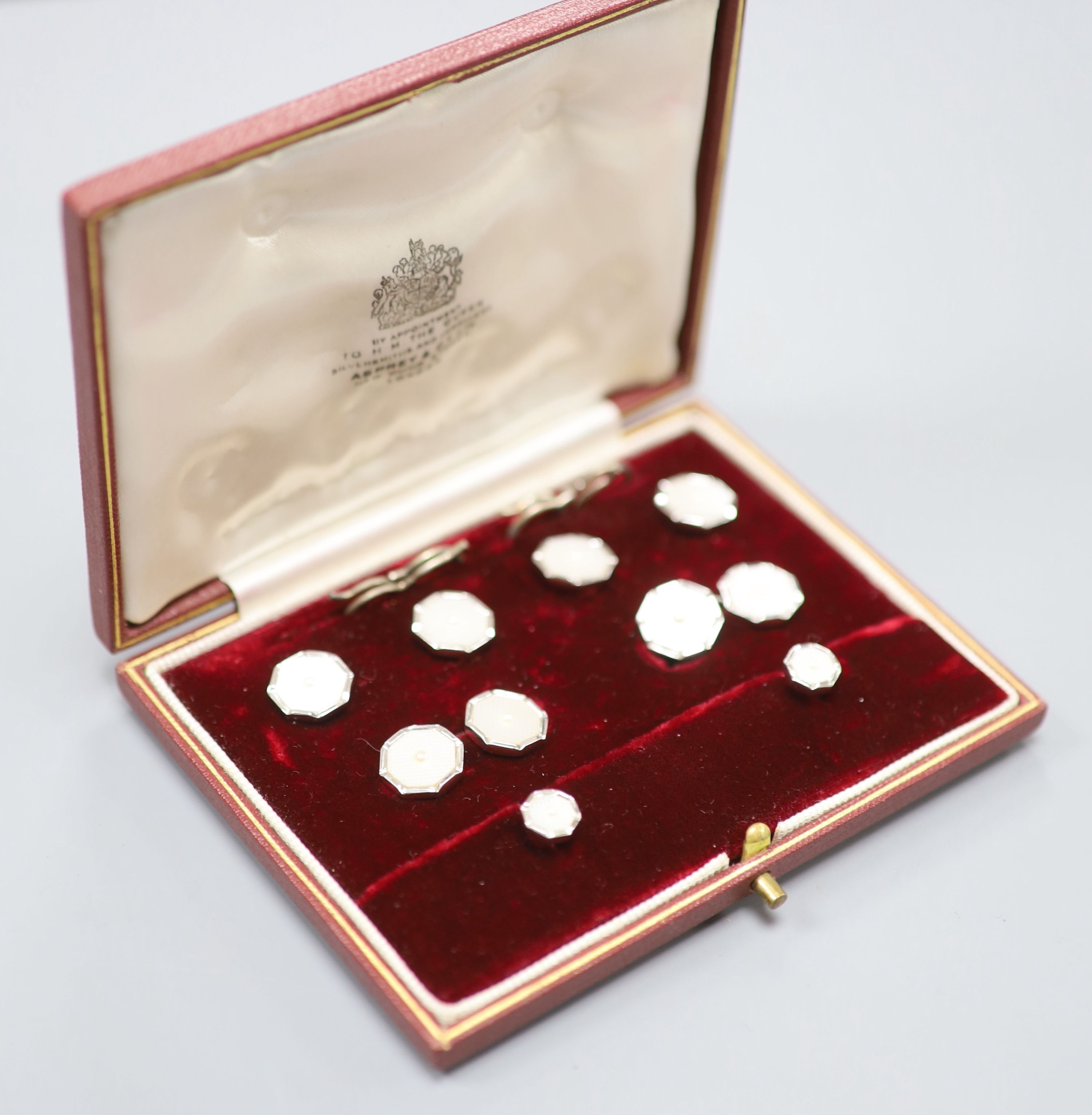 A gentlemens 9ct white gold and mother of pearl dress set of octagonal form, cased,